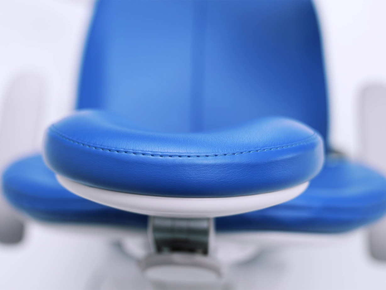 Close view of the top of sewn upholstery on an A-dec dental chair's headrest